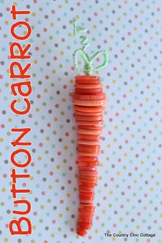 an orange carrot is hanging from a string on a polka dot background with the words button carrot