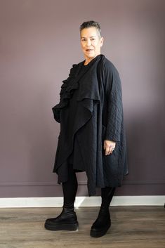 Designed for versatility, the Black Ruffle Jacket can be worn as a cardigan with a stylish ruffle or buttoned up your way for a unique look. Made with quality fabric, this jacket offers endless possibilities to elevate any outfit. Perfect for the fashion-forward individual seeking a customizable, chic wardrobe staple. Robin is 5’ 2” and is a size 8/10 and is wearing a size S/M Sizing: S/M= 6-10, L/XL= 12-16, XXL/XXXL= 18-2X 100% Cotton Machine Wash Cold Style: 71309 Lagenlook Long Sleeve Outerwear For Work, Long Sleeve Ruffled Blazer For Work, Long Sleeve Ruffled Blazer For Fall, Black Ruffled Outerwear For Fall, Black Lagenlook Outerwear For Work, Black Long Sleeve Blazer With Ruffles, Winter Outerwear With Ruffles For Layering, Winter Ruffle Outerwear For Layering, Winter Ruffles Outerwear For Layering