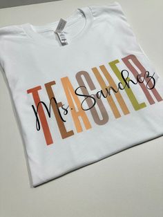 Show your appreciation for your favorite teacher with our Personalized Teacher Shirt! This custom tee makes the perfect gift for new teachers or as a thank you to your mentor. Celebrate their dedication with this unique and thoughtful Teacher Appreciation Gift. How to order 1-pick size and shirt color 2- Add to cart 3- go to cart and in the instructional box enter the custom name Example: Mrs Hernandez 4-Checkout T-shirt .unisex .eco friendly . regular size . soft & comfy