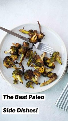 broccoli florets on a white plate with a knife and striped napkin