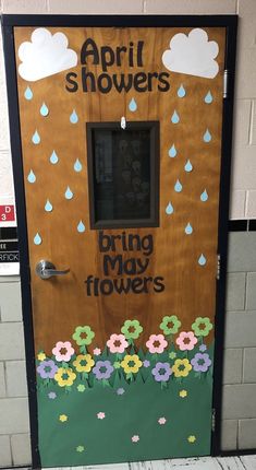 a door decorated with flowers and raindrops for the spring showers event at school