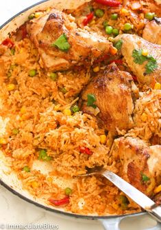 chicken and rice in a skillet with a serving spoon on the side, ready to be eaten