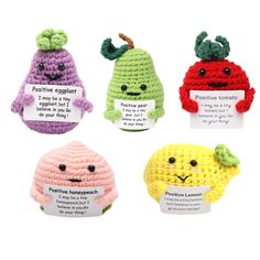 four crocheted amigurt toys with labels on them that say positive, negative, negative and negative