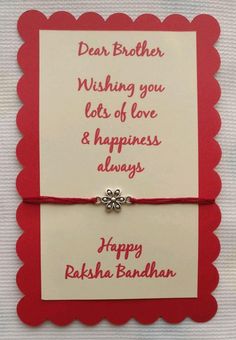 a red and white greeting card with a silver charm on the clasp that says dear brother, wishing you lots of love & happiness alwayss