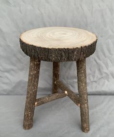 a small wooden stool made out of logs