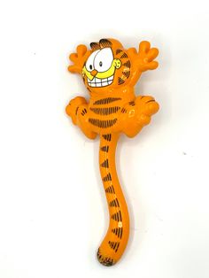 an orange and black cartoon figure on a white background