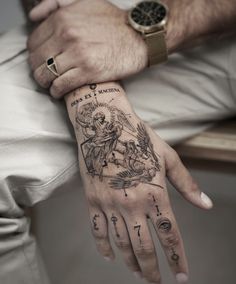 a man's hand with a tattoo on it