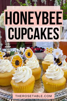 honeybee cupcakes with whipped cream frosting on a platter and flowers