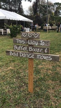 a wooden sign that says this way to buffet booze and bad dance moves