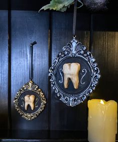 an elephant ornament hanging on a wall next to a candle and some candles