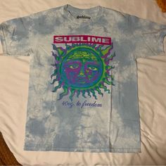 Features/Description: Light Blue And White Tie Dye Shirt. Sublime Sun 40 Oz To Freedom Logo On The Front. Condition: Brand New Shirt That Has Never Been Worn, Used, Or Washed. No Stains Or Damages. No Tags. Measurements: Mannequin Is A Women’s Size Small For Reference. Garment Labeled Size Medium. Unisex Sizing. Measurements Are Taken Laying Flat And Are Approximations: Chest: 19" Length: 26.5" Color Of The Garment May Appear Different Due To Lighting And Screen Differences. Blue Printed Shirt For Streetwear, Blue Summer Streetwear Tops, Light Blue T-shirt For Summer Streetwear, Light Blue Summer T-shirt For Streetwear, Fitted Blue Shirt With Sublimation Print, Blue Cotton Shirt With Sublimation Print, Blue Summer Streetwear Shirt, Blue Screen Print Shirt For Summer, Light Blue Spring Streetwear Shirt