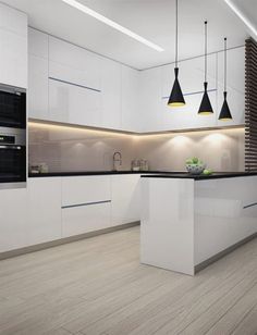 a modern kitchen with white cabinets and black lights hanging from the ceiling over the island