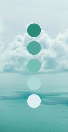 the sky is filled with white and green circles in front of some blue ocean water