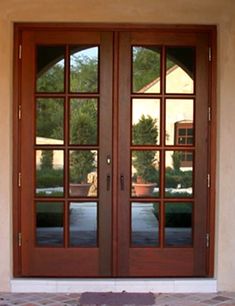 two brown double doors with glass panes