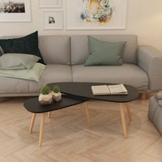 a living room filled with furniture and pictures on the wall