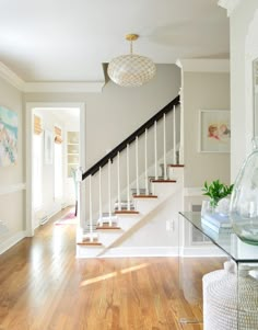 there is a glass table in front of the stairs