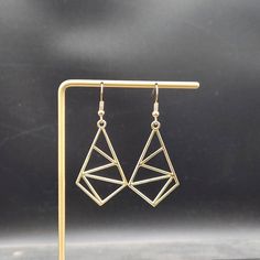 "These geometric earrings feature 40mm x 24mm geometric diamonds made of a gold-toned zinc metal alloy with 4 bisecting lines.  These minimalist geometric earrings will complement any outfit, and are lightweight enough for all day wear! The earrings measure approximately 2.25 inches from the bottom of the diamond to the top of the ear wires, which are made of hypoallergenic gold-plated surgical steel, making them safe for sensitive ears.  These earrings are featherweight, weighing just 0.1 ounce Earring Inspo, Diamond Shape Earrings, Geometric Diamond, Silver Spring, Diamond Shaped, Geometric Earrings, Sensitive Ears, Ear Wires, Diamond Shapes