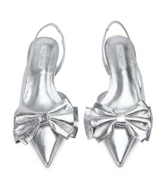 Make a statement in our Ella silver vintage low heel. Boasting an oversized bow on the tip of the shoe and a classic slingback silhouette. You'll be reach for this classic low heel all season long. -Material: Leather -Sole: Man-Made -Fit: True to Size -Toe-shape: Point -Features: Bow Detailing -Heel: 2.5cm Elegant Silver Pointed Toe Flats, Silver Slingback Heels With 4-inch Heel, Silver Almond Toe Sandals With 4-inch Heel, Silver Pointed Toe Heels With 4-inch Heel, Thigh High Boots Flat, Metallic Silver Pointed Toe Heels With 4-inch Heel, Embellished Heels, Metallic Heels, Low Boots