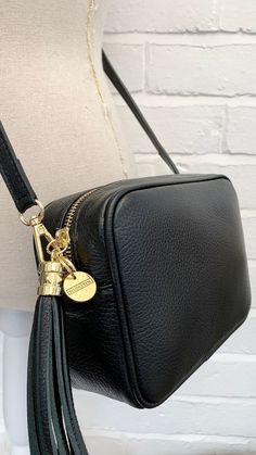 The last day to place Christmas orders for delivery within the UK is Monday the 18th by 11am. Merry Christmas from STUDIO TEW x Fall in love with the Darcy Bag - a stylish and timeless leather crossbody bag with a beautiful tassel and adjustable strap. Perfect for every day use, this bag is sure to bring out your sense of fashion! Get yours today - you won't regret it! ABOUT THE DARCY BAG Made from genuine Italian leather Gold metal hardware  Tassel detail One internal slip pocket, suitable for cards and keys Dimensions: L: 21CM H: 14.5CM D: 7CM Detachable & adjustable matching leather strap Length of strap including clasps - up to 135cm Handmade in Italy Available in a variety of colours All orders are dispatched in 1-3 working days, from the UK, via Royal Mail. Luxury Gold Bags With Tassels, Elegant Crossbody Bag With Tassels, Gold Tassel Bag For Gift, Elegant Tassel Pouch Shoulder Bag, Bag With Tassel, Butterfly Scarf, 3rd Anniversary Gifts, Bridesmaid Bags, 3rd Anniversary