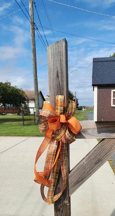 a wooden post with a bow on it