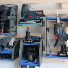 several tools are displayed on shelves in a garage