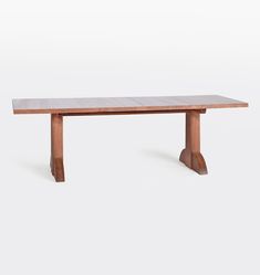 a wooden table sitting on top of a white floor