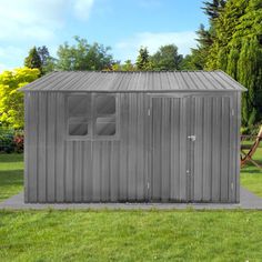 a metal shed sitting on top of a lush green field