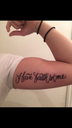 a woman's arm with the words have faith in me tattooed on it