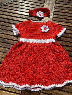 "Welcome To SaminasCrochetDesign In search for the perfect unique baby gift? Everyone will ask where you got it from. Look no further!  🧶 Crochet dress 🧶 Crochet baby dress, 6 to 9 months This is a gorgeous handmade crochet dress with a matching headband, made with 100% soft acrylic in bright orange with a white contrast which makes the outfit pop!. The yarn is 4 ply which means the dress is not too heavy and creates a lovely drape.  The dress should fit 6 to 9 months old, depending on the size of your baby. The dress is 20\" (50cm) long from the shoulder to the hem. Chest circumference is 20\" (50cm). The dress has a square neckline with a stretchy waistband detail which gives a better fit. The dress has a full skirt in a pineapple design with a white shell pattern edging.  A beautiful Handmade Cotton Crochet Dress, Crochet Strawberry Dress, Crocheted Baby Christmas Dresses, Disney Crochet Dress Baby, Crochet Frocks For Baby Girl, Crochet Baby Frock, Pineapple Design, Shell Pattern, Crochet Gift