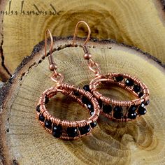 the earrings are made with copper wire and black beads