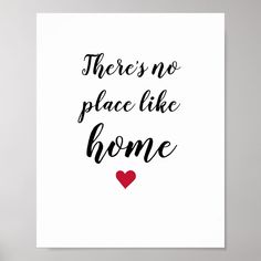 there's no place like home with a red heart on the front and black lettering