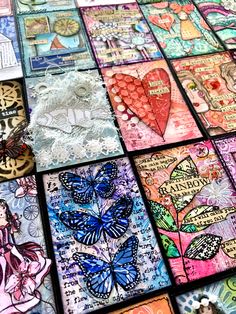 there are many different cards on the table with each one's own heart and butterfly designs