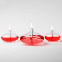 three red candles sitting next to each other