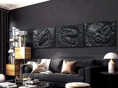 a living room filled with black furniture and art work on the wall above it's coffee table