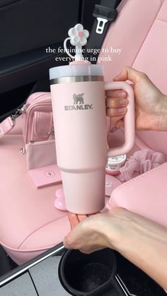 a person holding a pink cup in their hand