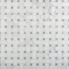 a white and grey tiled wall with squares