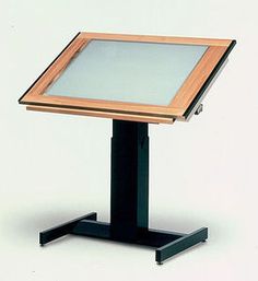 a wooden table with a glass top and black stand on it's legs, against a white background