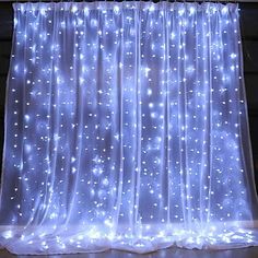 the curtain is lit up with lights and sparkles on it's side wall