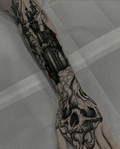 a person's arm with a tattoo on it and a clock tower in the background