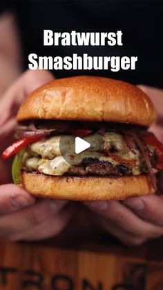 someone holding a hamburger in their hands with the caption brawurst smashburger