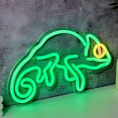 a green neon sign sitting on top of a counter