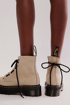 **Fit Note:** If in between whole sizes, we recommend sizing down. Rugged, military-inspired boots from Dr. Martens featuring a chunky, 8-eye design with a zip-up tongue that stays true to the brand’s iconic DNA with yellow stitching and grooved edges. * Lace-up and zip-up design * Air-cushioned sole * Slip-resistant | Dr. Martens Sinclair Zip Front Boots at Free People in Grey, Size: US 9 Dr Martens Sinclair, Winter Shoes Boots, Doc Martens Boots, Doc Martin, 500 Miles, Fall Boots, Military Inspired, Eye Design, Doc Martens