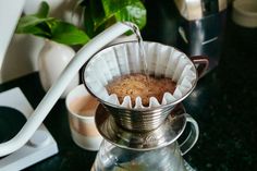 a coffee pot filled with liquid on top of a table