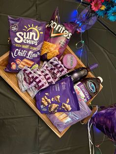 an assortment of snacks and condiments laid out on a tray with purple lights