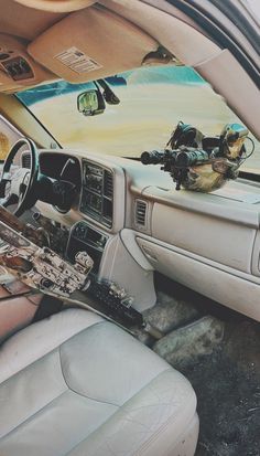 the interior of a car with an assortment of items on it's dash board