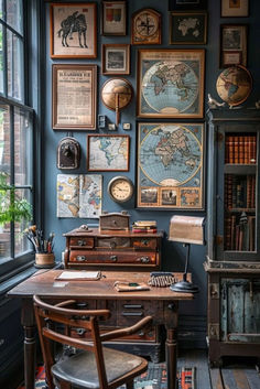 an old desk in front of a window with many pictures on the wall above it