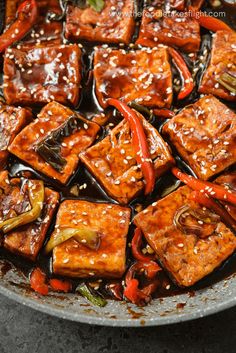 tofu with peppers and sesame seeds in a wok