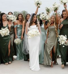 the bride and her bridal party are all dressed in green dresses with white bouquets