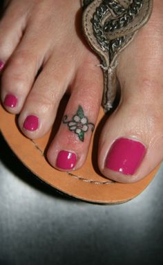 a close up of a person's feet with pink nail polish