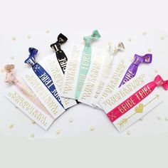 six different colored hair ties on top of each other in various designs and colors,